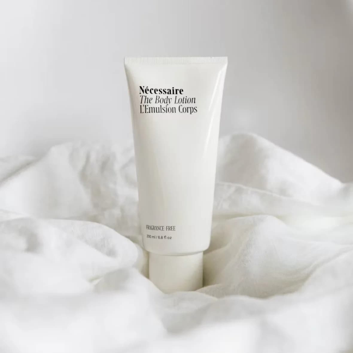 Post-Treatment Recovery Balm, white 50 ml tube resting on soft white linen