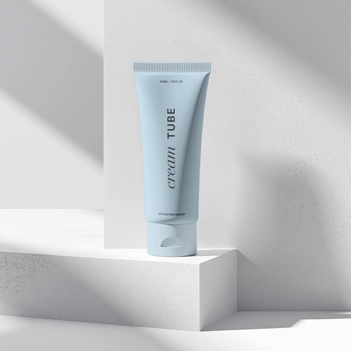 Mineral SPF 50 Daily Defence, pale blue tube on a white stone plinth in sunlight