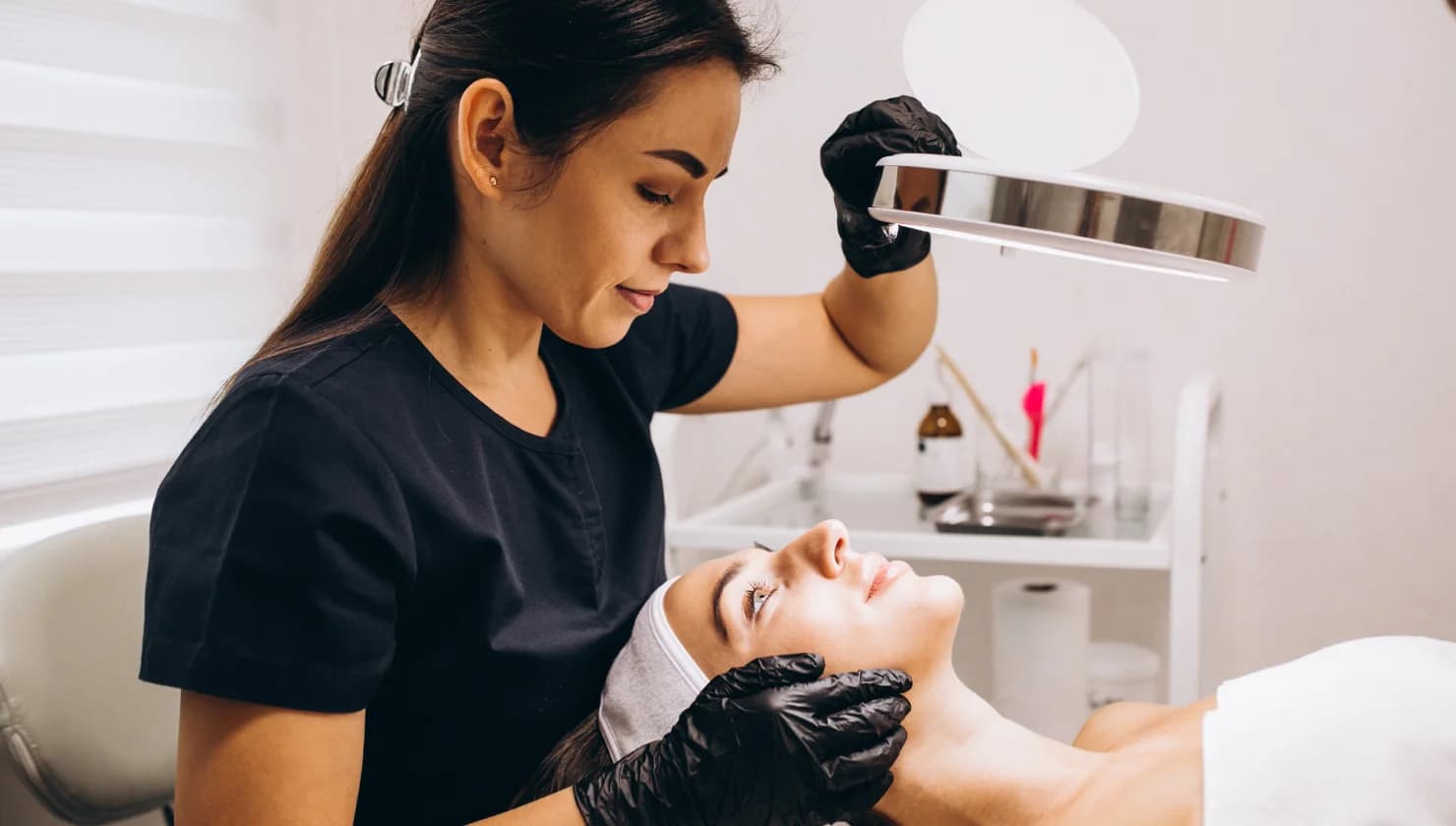 Practitioner carrying out an advanced facial treatment